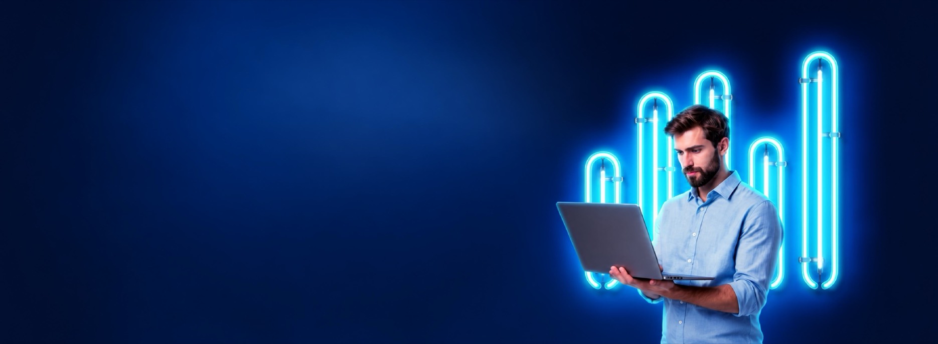 Trader holding a laptop in front of neon charts